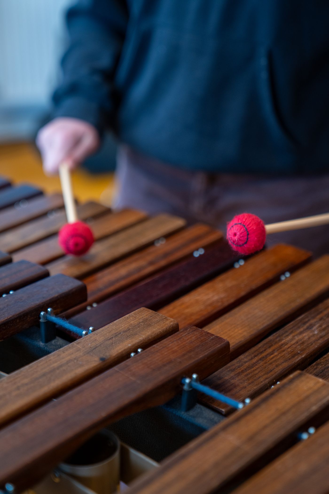 Musician playing a marimba with red mallets